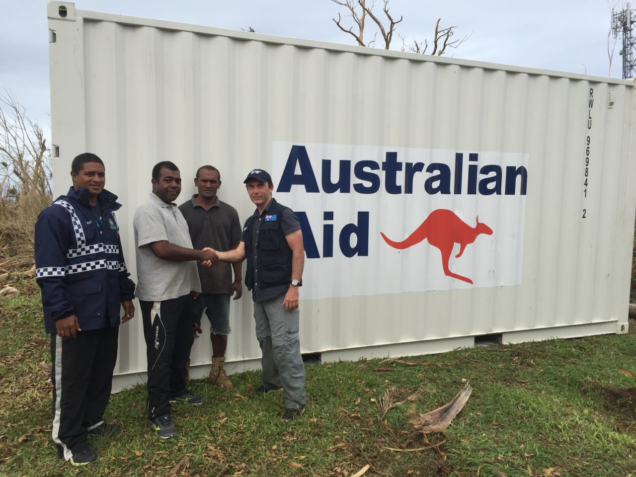 DFAT officer Cameron Noble delivering aid supplies to local government officials in Fiji. [DFAT/Cameron Noble]