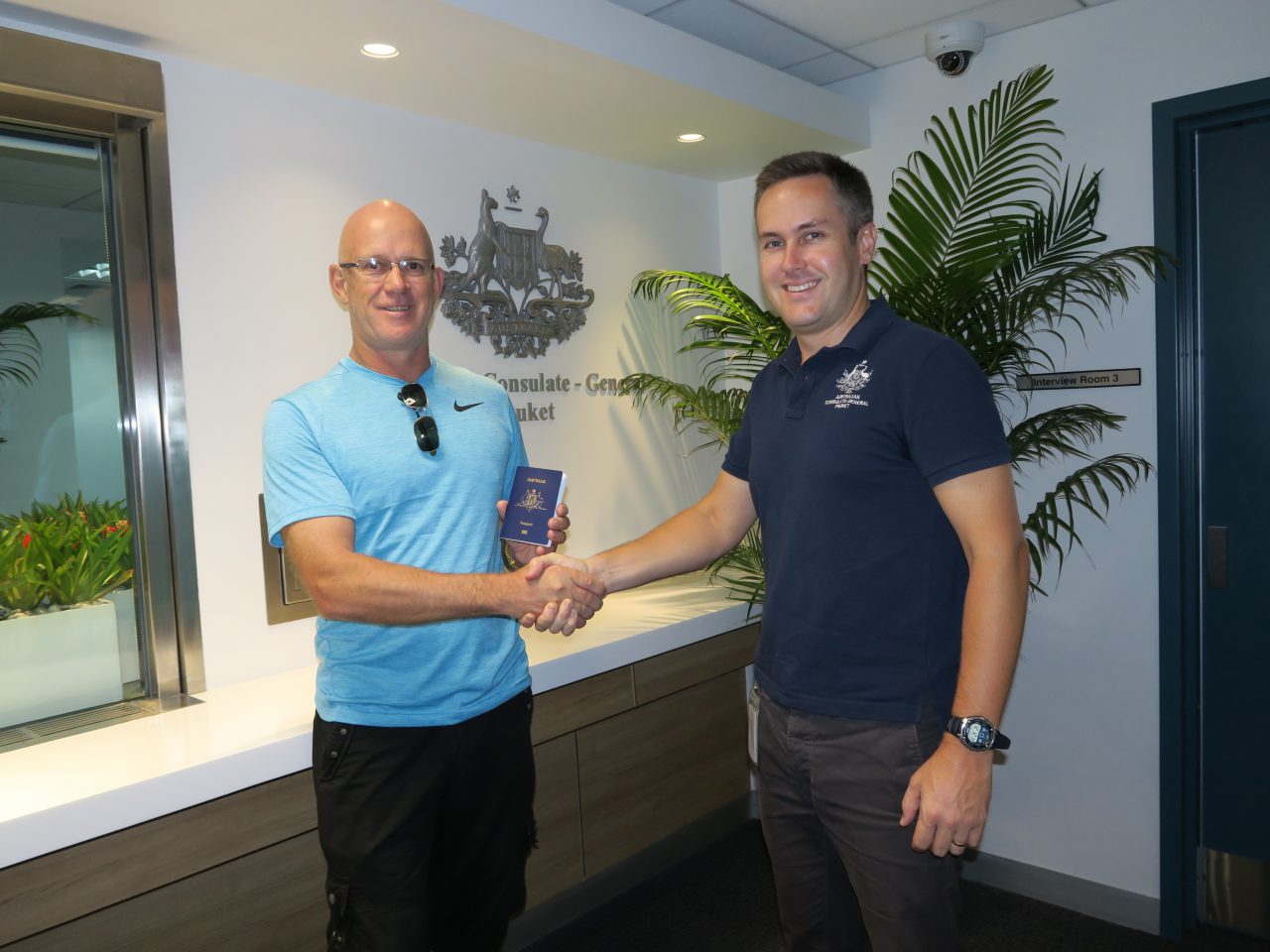 Consul-General to Phuket Craig Ferguson with the first passport client at the new Consulate-General in Phuket. [DFAT/Wootikrai Jitsmark]