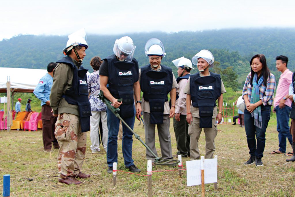 First Secretary Simon Buckley using a mine detector at the mine detection training zone in Battambang Province, Cambodia