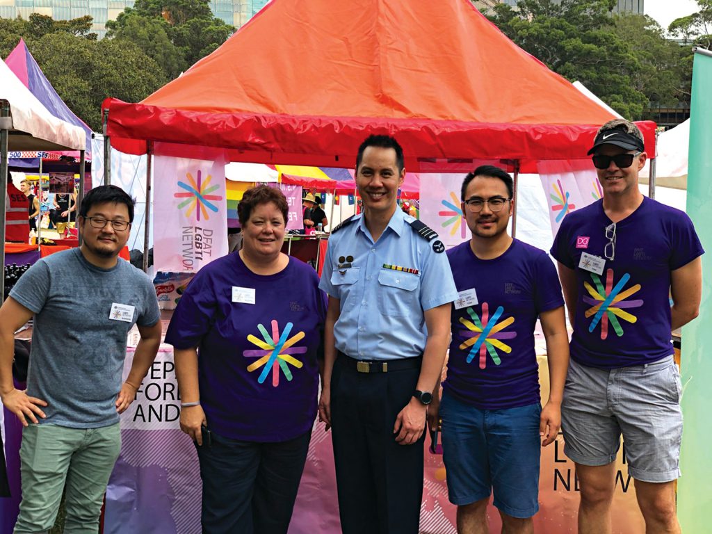 The LGBTI Network Committee members at the department’s Mardi Gras Fair Day stall, with Wing Commander Vince Chong of Defence’s DEFGLIS
