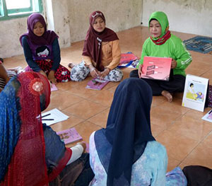 Women having a discussion around a table.