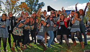 Photo of a group of young people smiling and waving