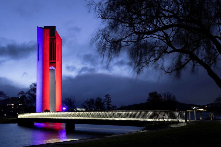 Image of National Carillon in Canberra lit up in blue and red