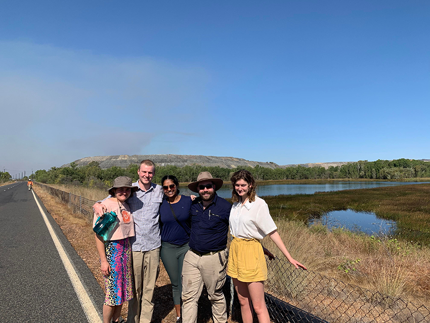 Harine and fellow students in the NT, standing on the road in front of a river