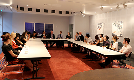 Students sitting around table engaging in discussion