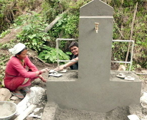 Villagers building a clean water outlet