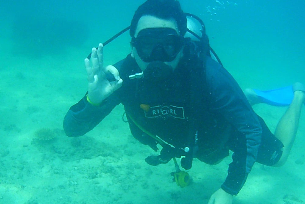 Photo of Dean McCarthy scuba diving underwater