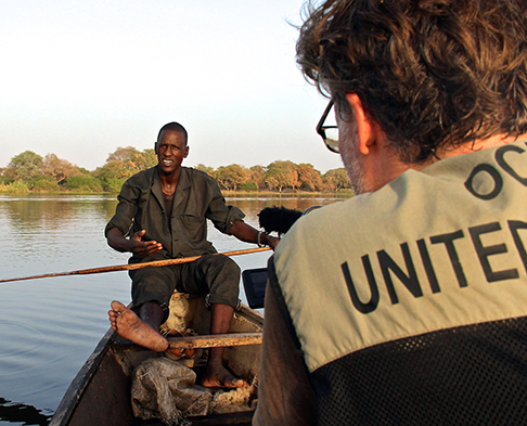 OCHA representative in a row boat with a man