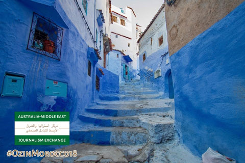 Photo of blue buildings, and a blue street staircase.