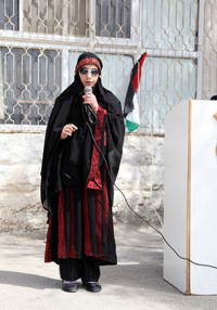 A blind girl singing a song at the celebration of the newly built WASH facilities at her school