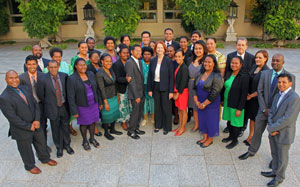 Large group of people in courtyard smiling at camera