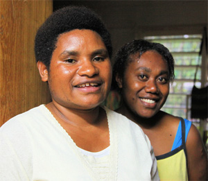Two women, smiling