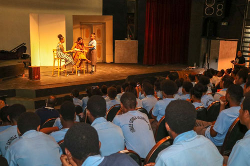 Emily and Mereani perform on stage for a crowd of students at a Youth Arts Program at Morseby Arts Theatre..
