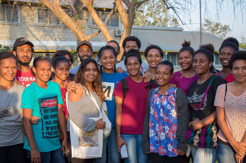 Emily Wurramara and Mereani Masani Official posing for photo with UPNG students.