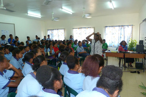 Ms Leila Gurruwiwi performing a traditional dance for PNG students in a classroom.