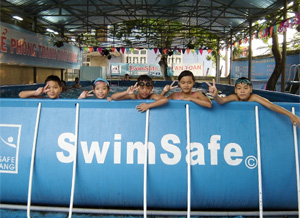 Vietnamese children in a portable swimming pool