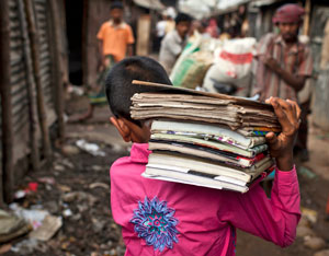 Boy carries books on his shoulder through