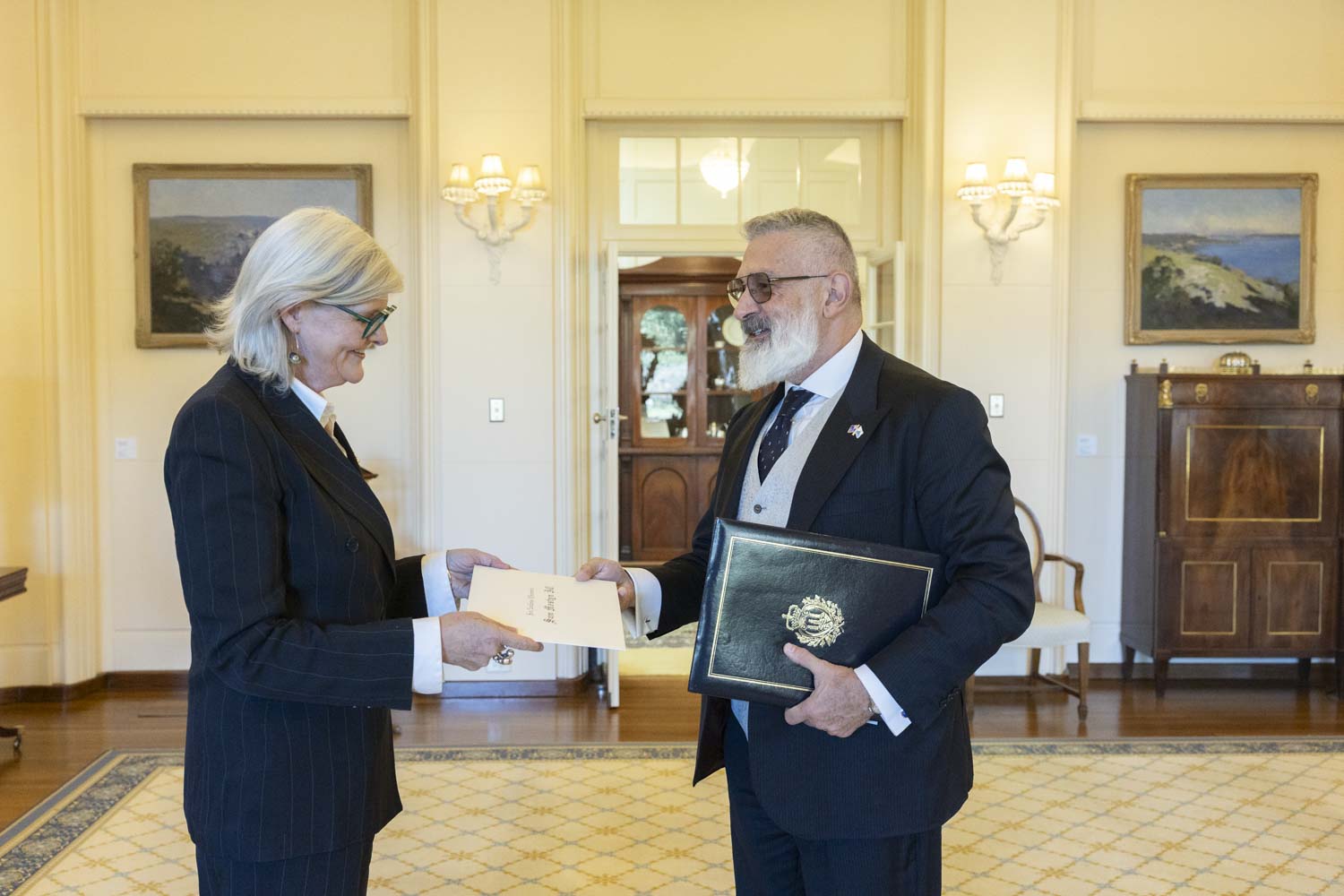 Image of His Excellency Mr Paolo RONDELLI, Ambassador of San Marino receiving a certificate from the Governor-General of Australia, Ms Sam Mostyn AC.