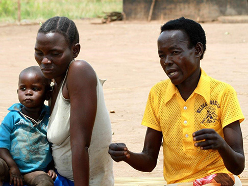Woman talking to another woman holding an infant