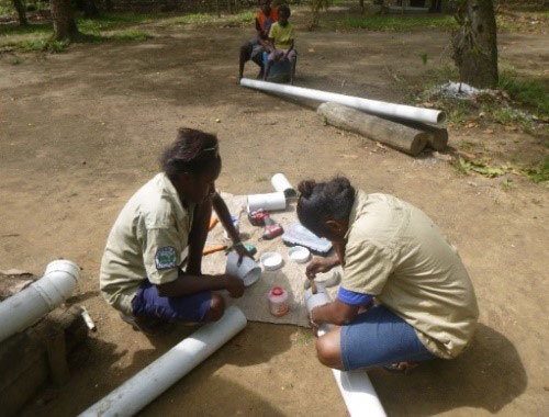 Photo of 2 rangers undertaking an activity for the Ranger program in PNG. 