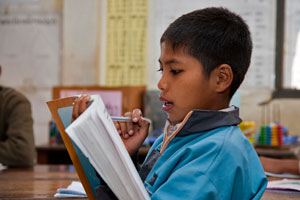 A grade 5 boy reads his textbook at Xayyathong school Beng district, Laos.