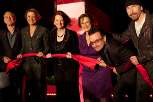 L-R: Adam Clayton-U2 bassist, Kristina Keneally-NSW State Premier, Julia Gillard-Prime Minister of Australia, Bono-U2 lead singer and Co-founder of (RED), The Edge-U2 guitarist all holding a red ceremonial ribbon.