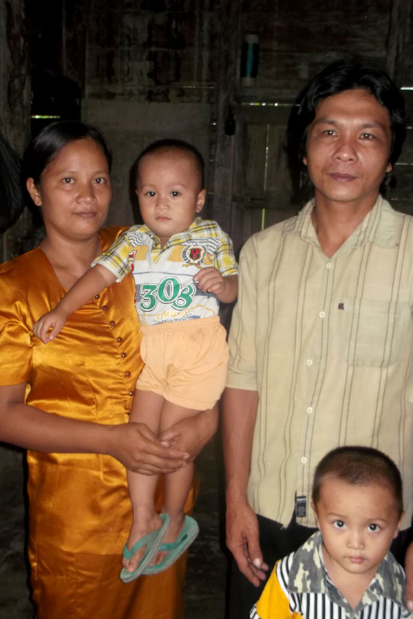 A mother a father with their baby and toddler.