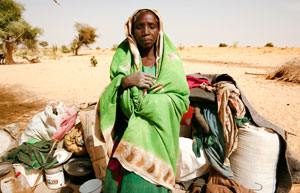 Photo of a refugee resting with her belongings