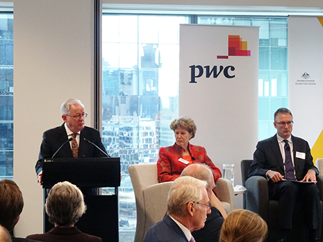 Minister Robb standing at a podium