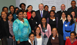 Mr Rudd and Mr Baxter standing with a group of people, smiling at camera.