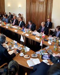 Photo of Foreign Minister Kevin Rudd and other countries' representatives in a joint meeting around a large table