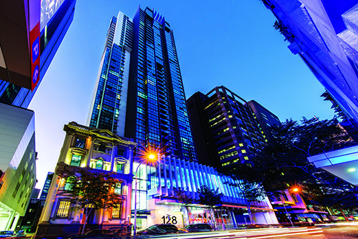 A high rise building in a city at dusk.