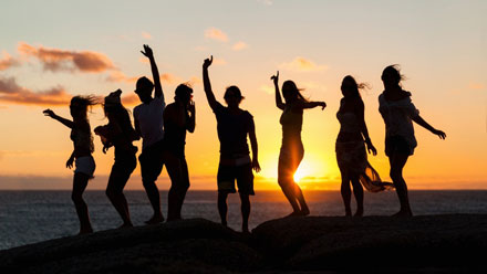 Photo: Eight partygoers in front of a sunset