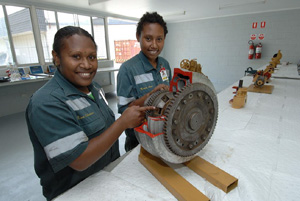Two female diesel fitters in a workshop