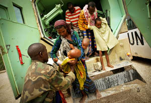 Refugees are helped out of a UN transport truck in Somalia