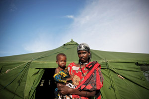 Woman with child in front of a tent in Somalia