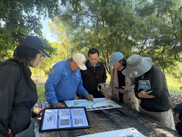 Participants review a coastal habitat map during a site briefing at Moreton Bay Fish Restoration.