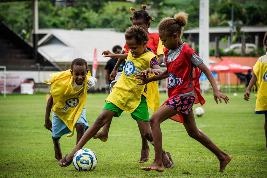 Children playing soccer as a part of the Just Play program in Vanuatu.