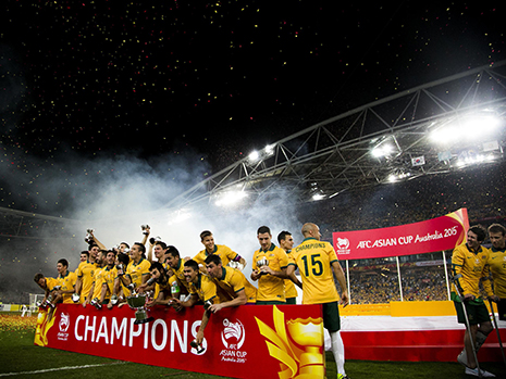 Australian team holding banner smiling