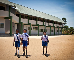 Students from Masar G.T.M.S walk across the yard of their newly construced school