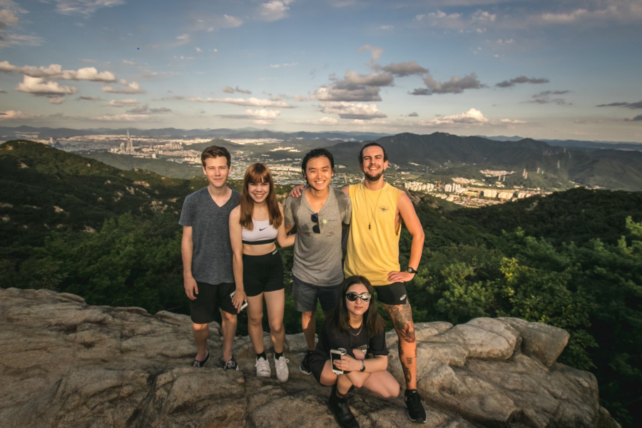 Group photo of five young people on a mountain.