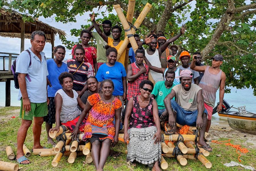 Group of staff sitting on their rafts.