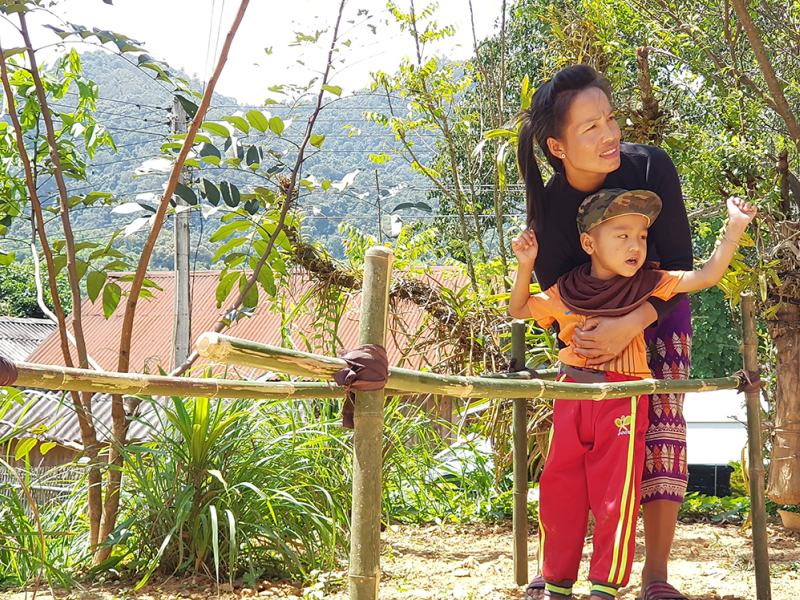 Ms Nang supports her son in his rehabilitation exercises.

