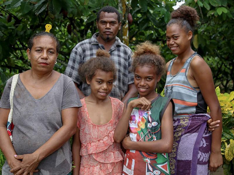 Arnold, his wife Ruthy, and their three children at his cocoa farm in the small village of Napapar, Papua New Guinea.