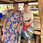 Jess Rodham sitting with a local resident of Nui Island