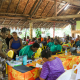 Photo of several participants gathered under a local Solomon Islands building. 