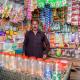 Photo of Anwar selling multiple products in an open street side store. 