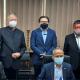 The group pose formally, wearing facemasks.