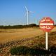 View of wind power turbines along an unsealed road in Morocco