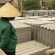 Vietnamese workers loading asbestos roof sheet
